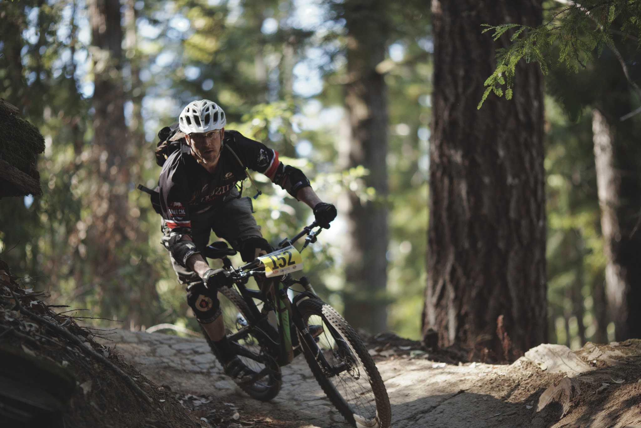 Dan King on a mountain bike in the middle of a forest