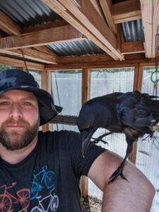 Joel with a crow on his elbow